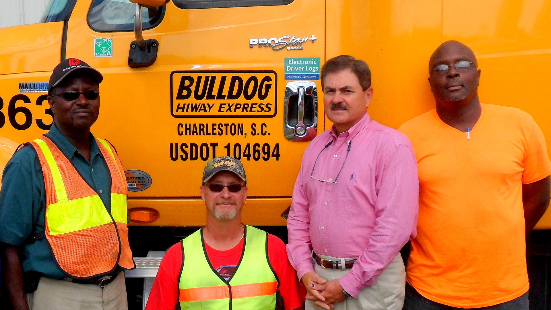 With Phil Byrd, president of Bulldog Hiway Express, (second from right), are senior drivers,(left to right), Robert Gibbs, Timothy Smith and Gerald Waring