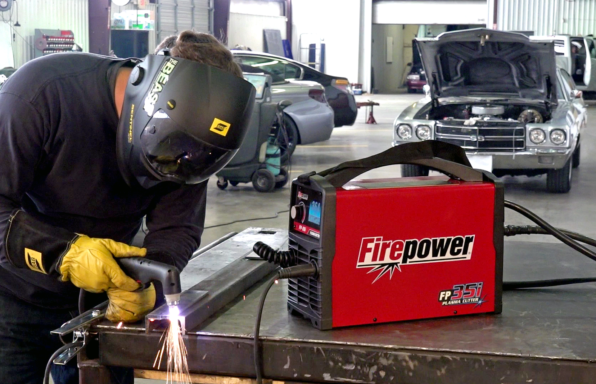 To create a smoother cut surface, the operator braces his left elbow on the table and uses his left hand to support the torch.
