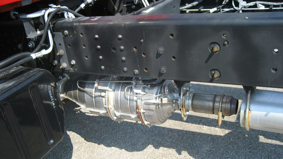Full exhaust aftertreatment system mounted to the bottom of the chassis rail on an Isuzu 7500.