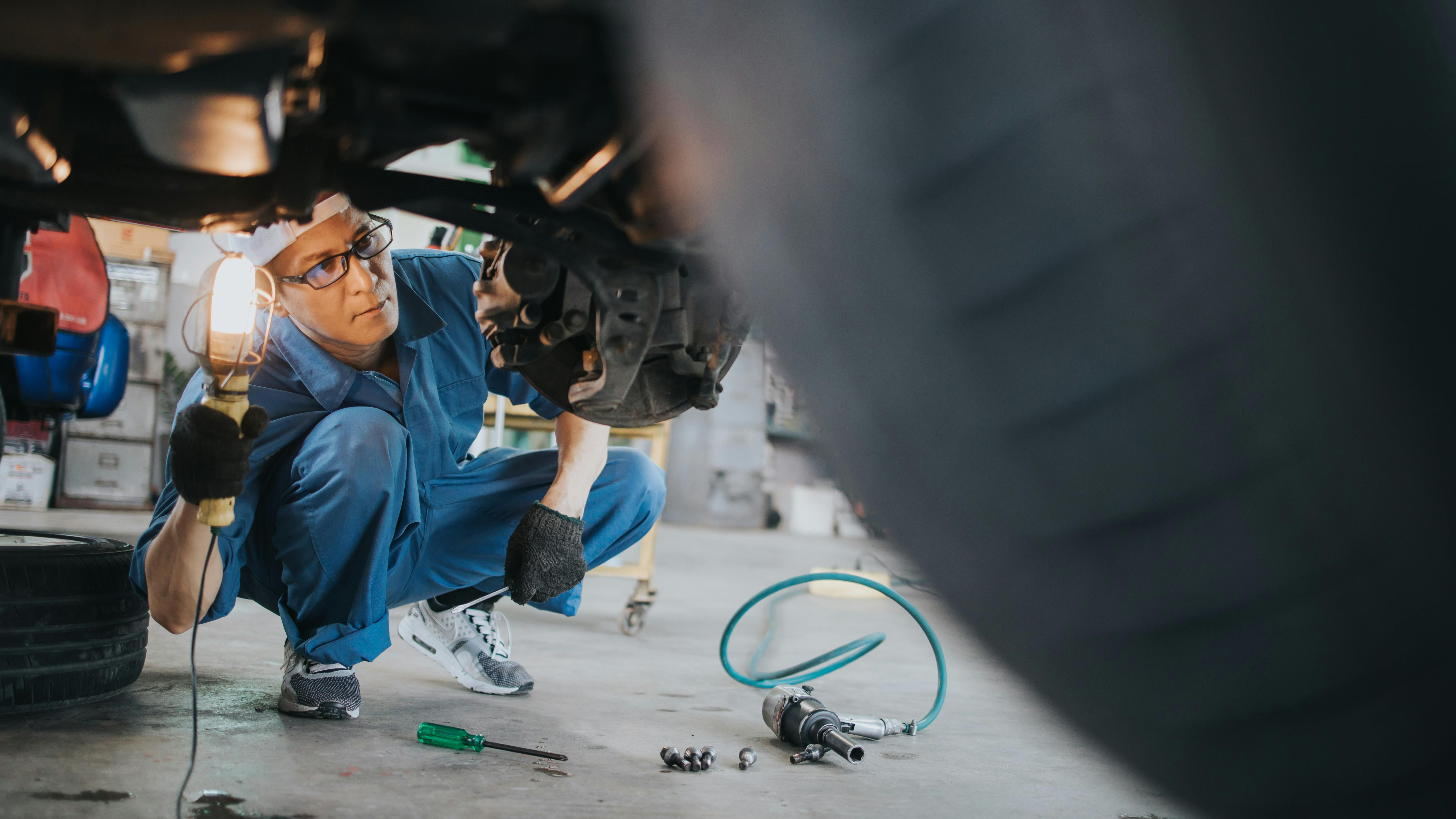 Technician Working on Brakes from Getty Images total cost of repair