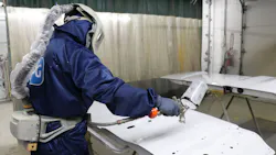 Fleet Fast's Francisco Esquivel dons his painting suit to apply a clear coat. Fleet Fast's Francisco Esquivel dons his painting suit to apply a clear coat.