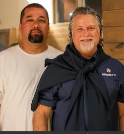 Cox Automotive technician Miguel Rodriguez with racing superstar Michael Andretti. Cox Automotive technician Miguel Rodriguez with racing superstar Michael Andretti.