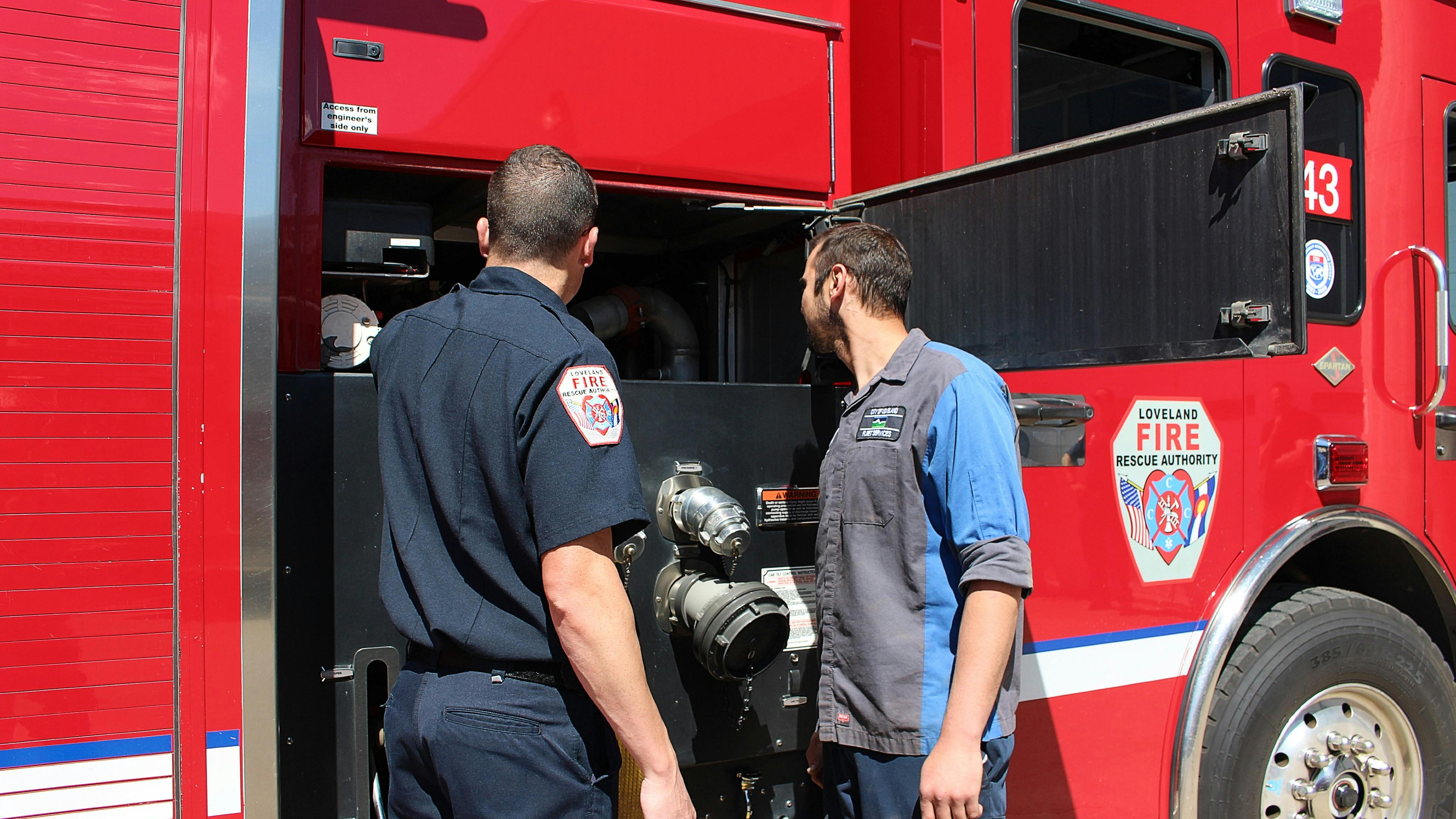 Loveland Fire Rescue Authority Engineer and City of Loveland Emergency Vehicle Technician troubleshooting a pump issue on a fire engine.