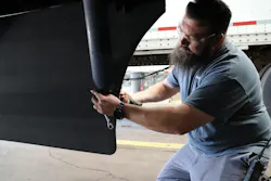 Technician works on a trailer fairing Technician works on a trailer fairing