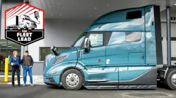 Service advisor posing with driver at truck Service advisor posing with driver at truck