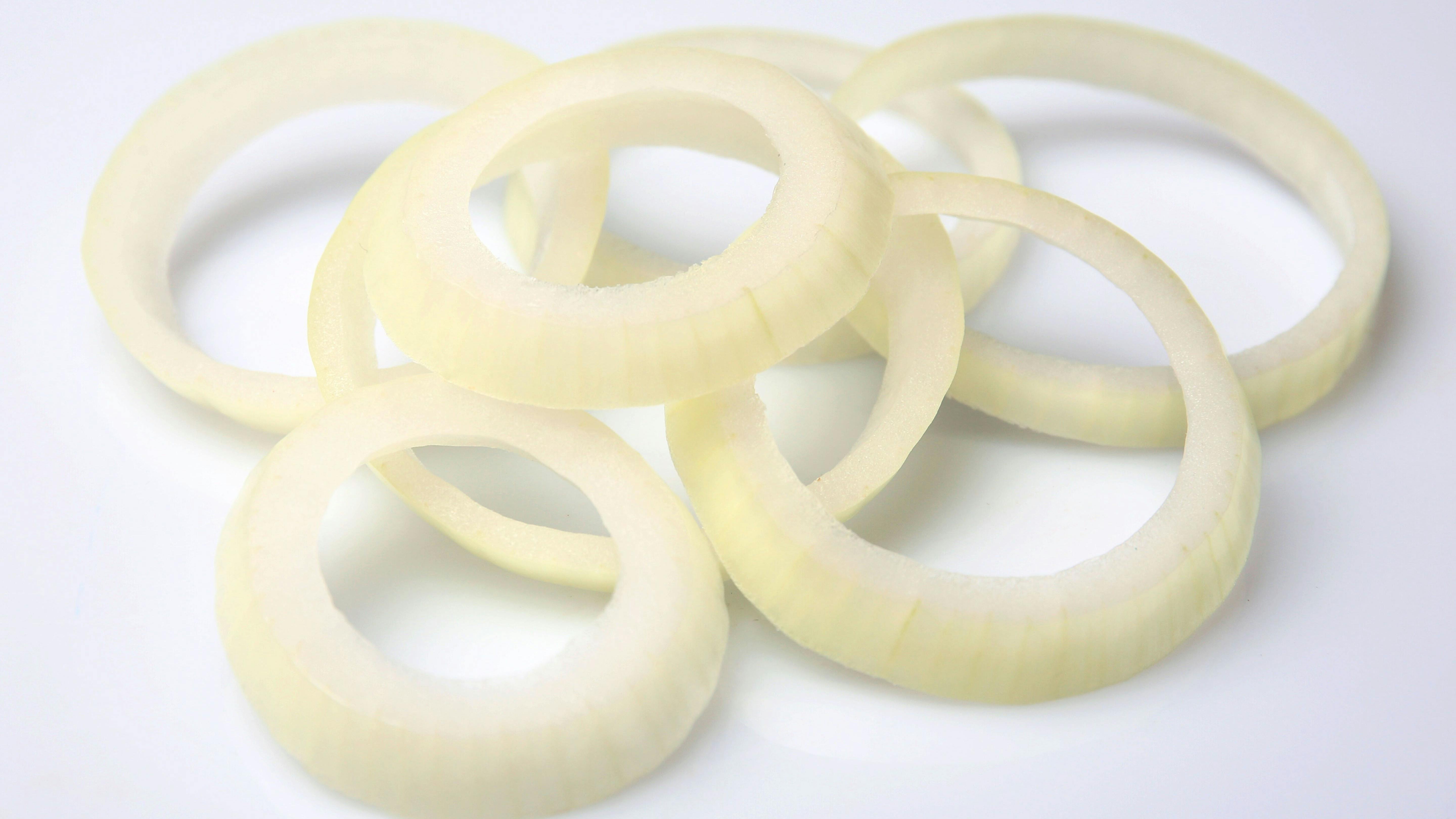 Sliced onion rings isolated on white