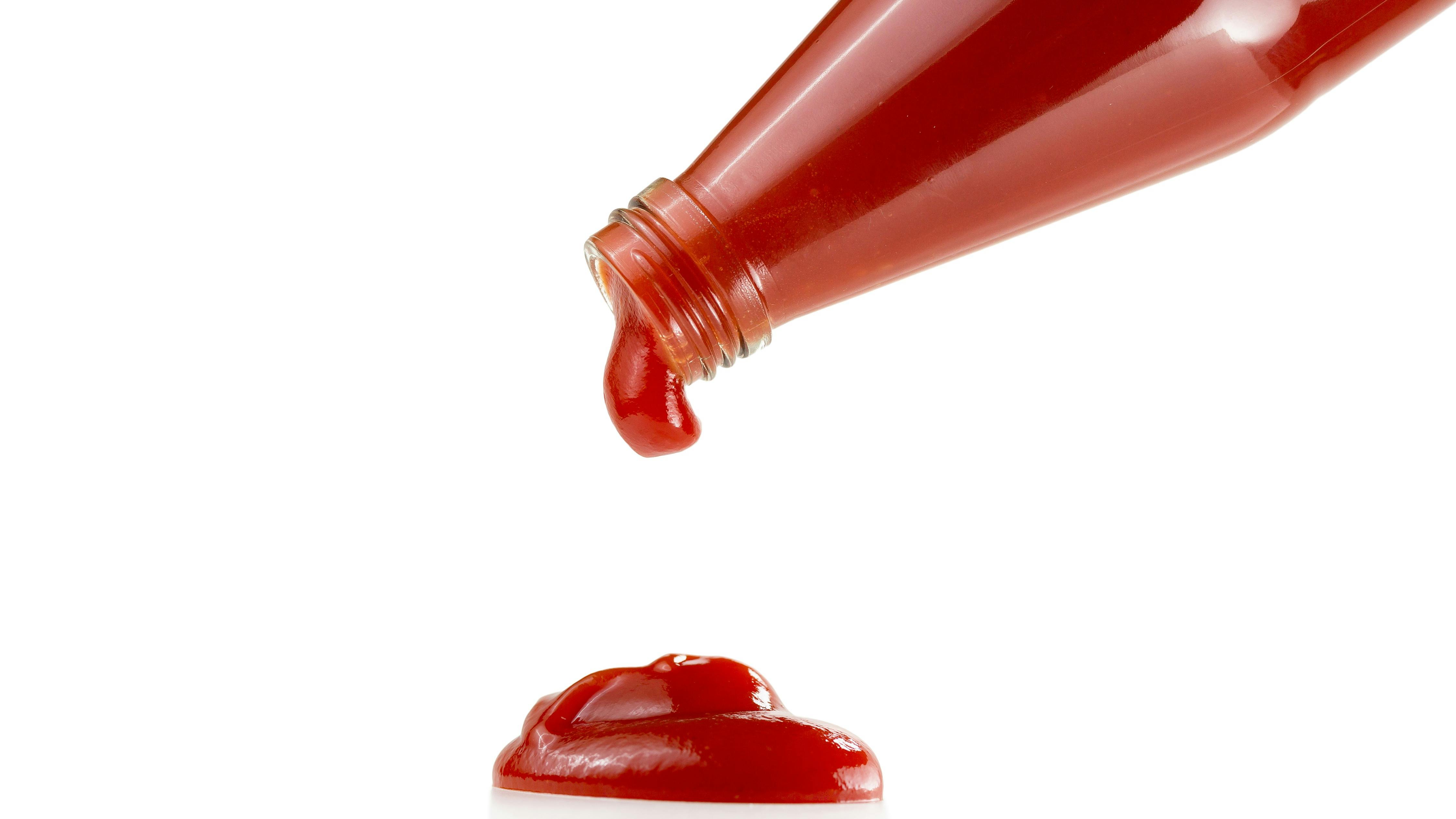 Tomato ketchup falling from bottle