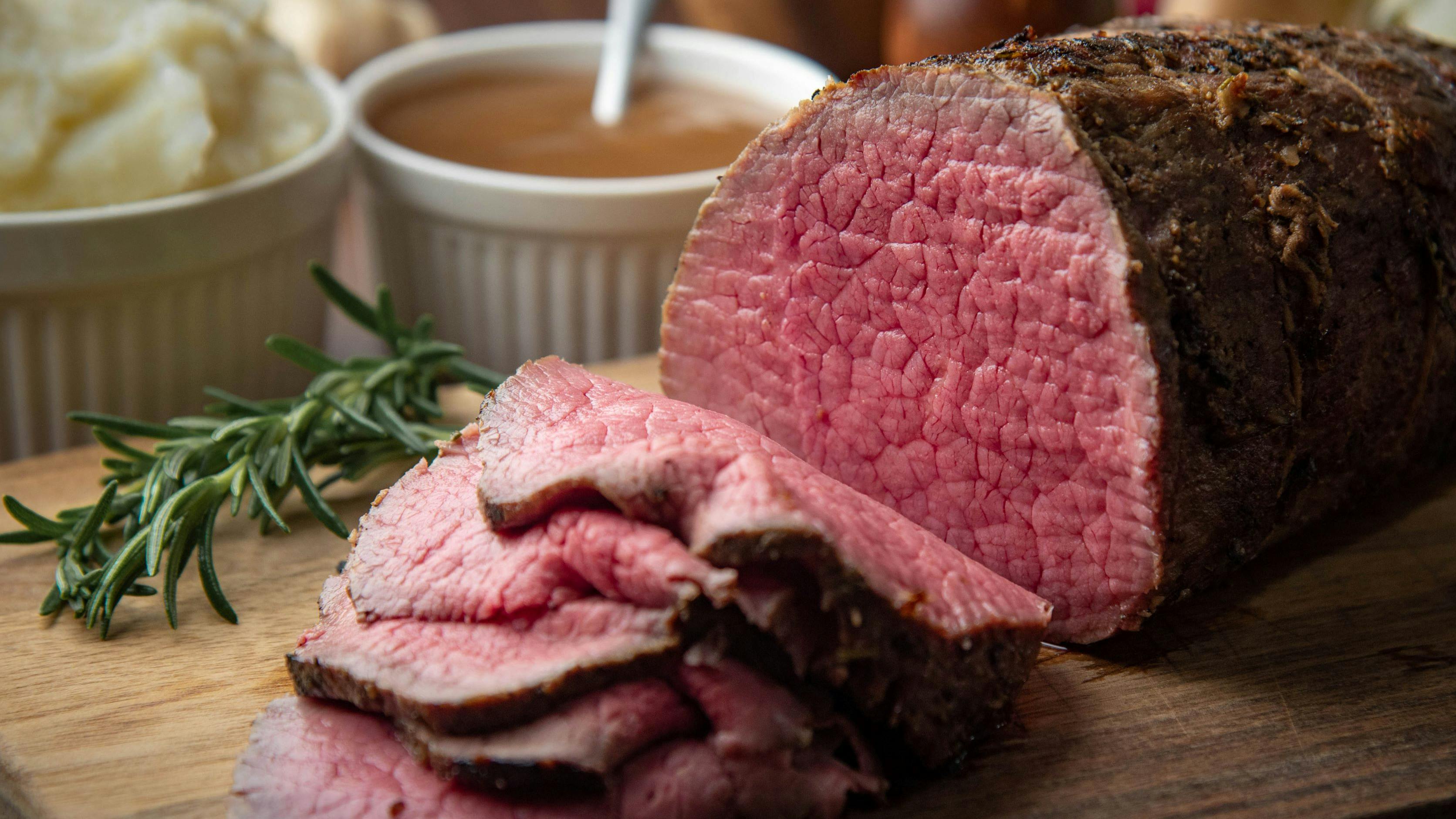 sliced eye of round beef roasted beef on cutting board