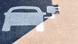 A painted road sign indicates an electric-vehicle recharging parking point. A painted road sign indicates an electric-vehicle recharging parking point.