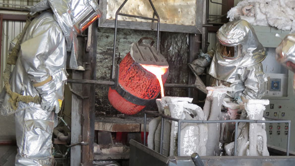 Pouring the molten bronze from the crucible into the investment shell requires skillful attention and a steady hand to produce a perfect casting