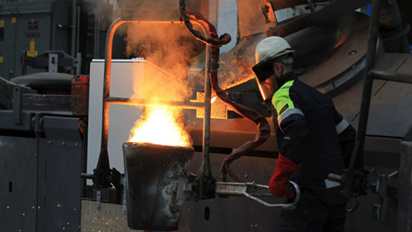 Pouring molten metal at William Cook Cast Products in Sheffield England