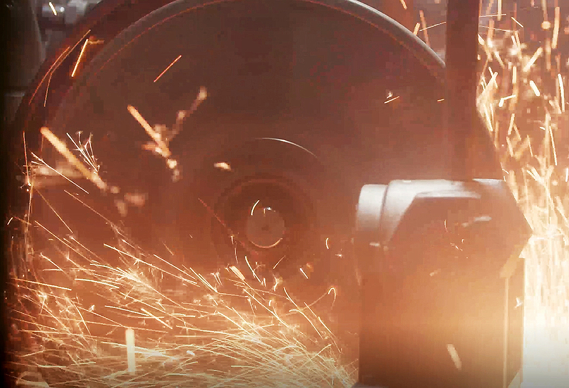 Grinding a cast iron part at Seneca Foundry.