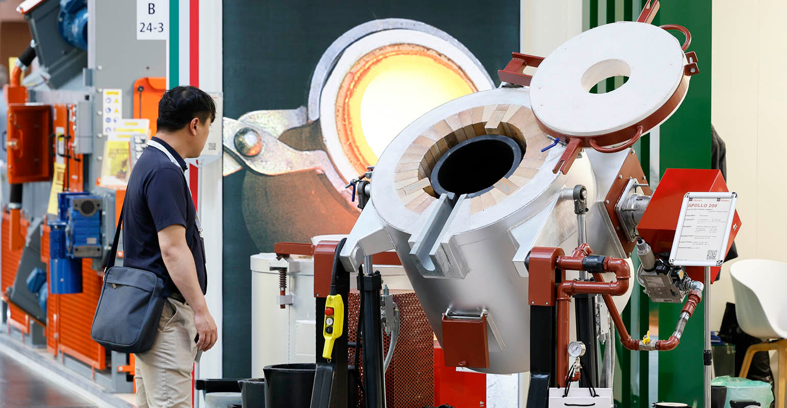 A GIFA 2023 visitor inspects an automated ladle system, D&uuml;sseldorf, Germany, June 2023.