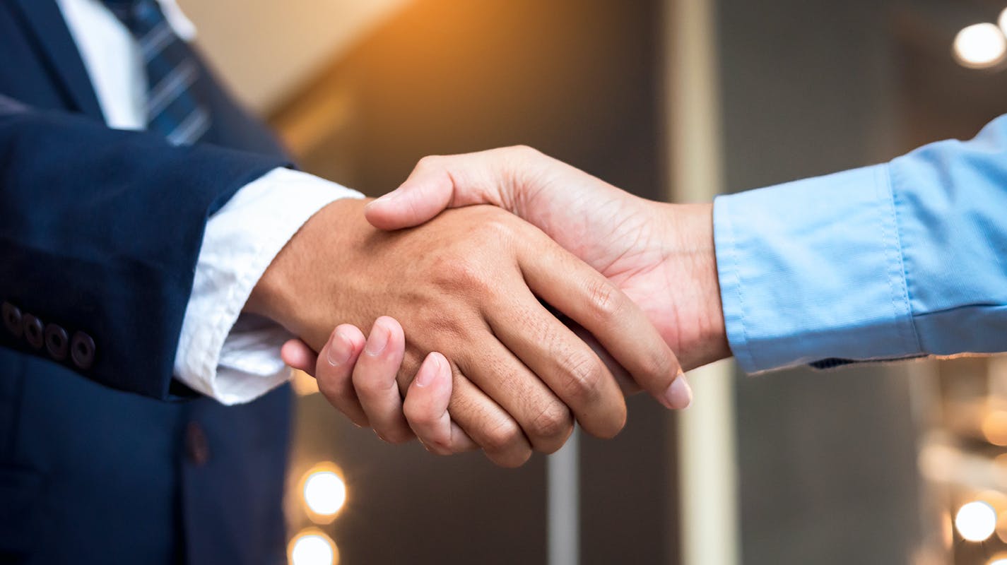 Businessmen shaking hands, close-up.