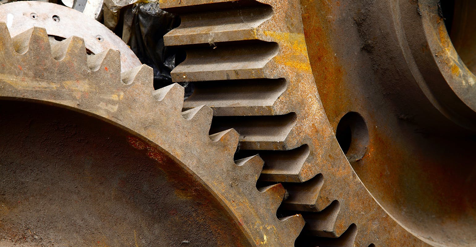 Corrosion on steel gears of an industrial crane.