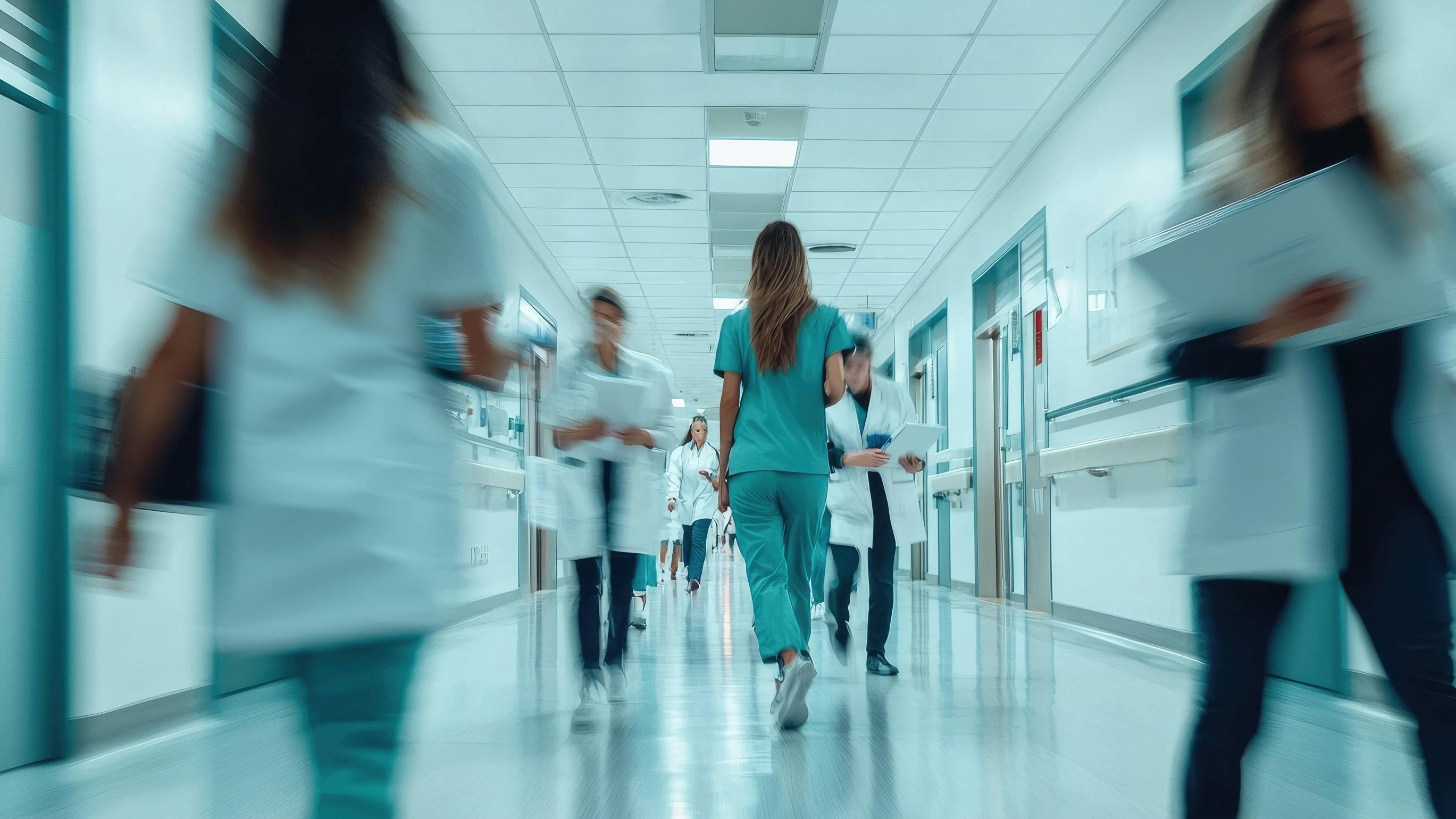 Blurred photo of health care professionals rushing in a hospital.