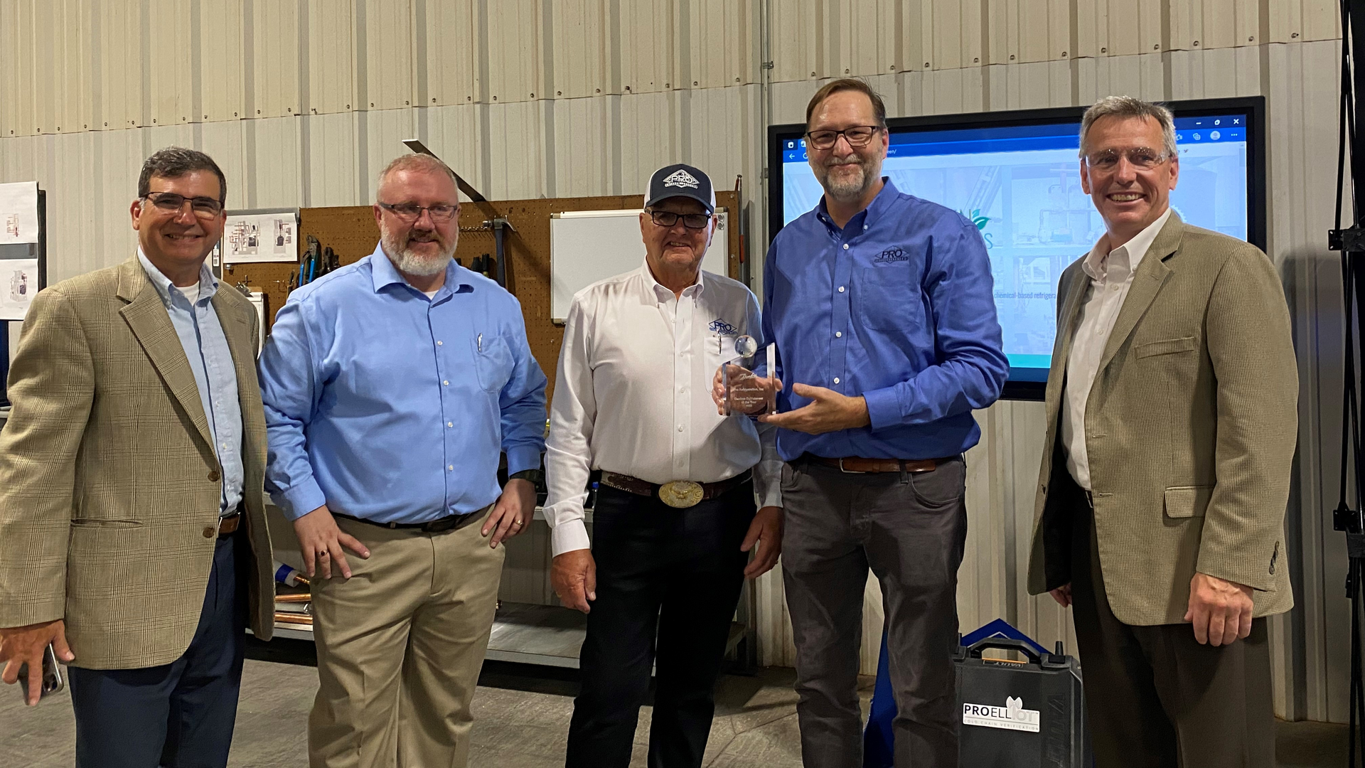 Pro Refrigeration's Jim VanderGiessen, Jim VanderGiessen, Sr., and Damon Reed receive the 2022 EoY Award from Danfoss North America president Rick Sporrer (far right) and regional manager Thomas Savas (far left) at Pro Refrigeration&rsquo;s Mocksville, NC, facility.
