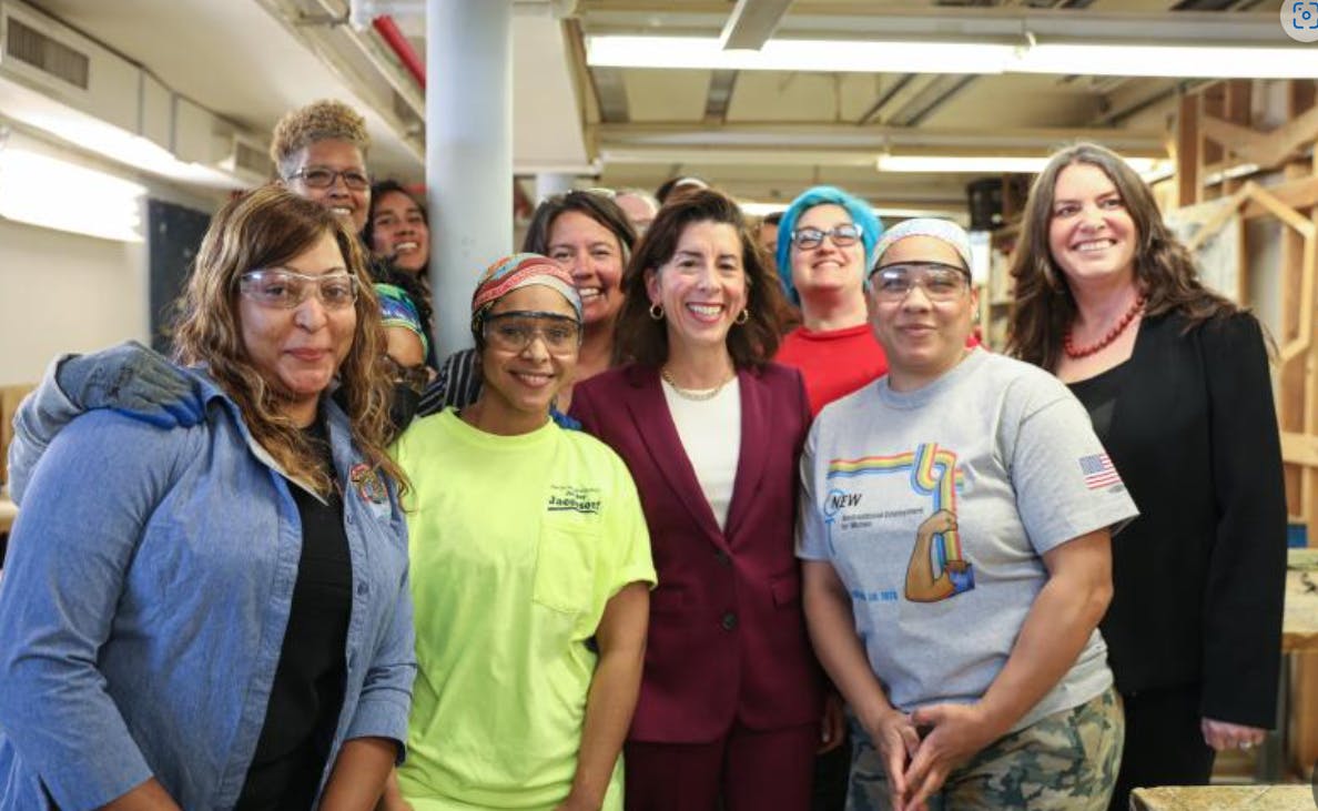 Secretary Raimondo surrounded by women in the trades.