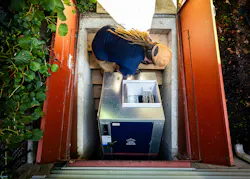 An installer carries a Dandelion Geo heat pump down into a homeowner's basement. An installer carries a Dandelion Geo heat pump down into a homeowner's basement.