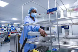 Tech II Jeanine Francois empties the washer disinfector. Tech II Jeanine Francois empties the washer disinfector.