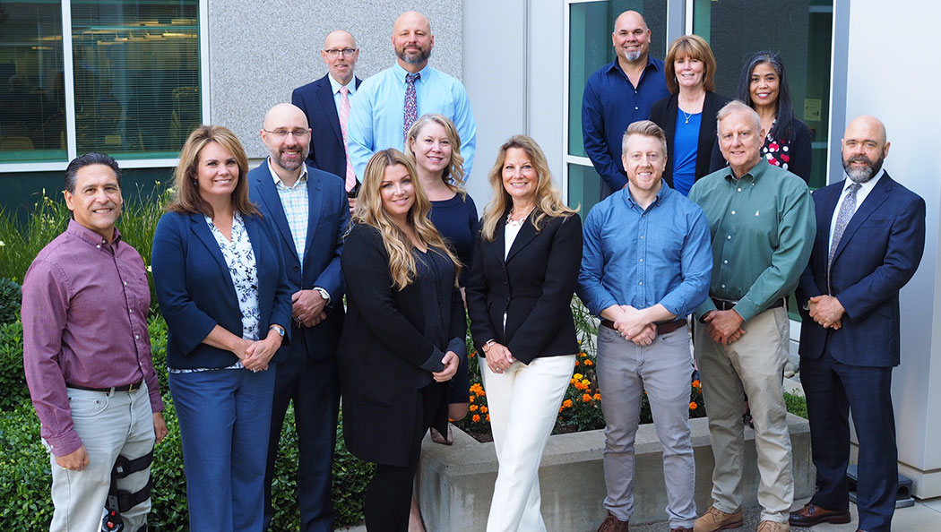 Front Row: Brian Pellowski, Stacy Jones, Brian Kay, Candice O&rsquo;Brien-Dominguez, Malia Weinberg, Karen Kelly, Josh Long, John Apostolo, David Hamlet. Back Row: Lee Ayers, Tom Billalon, Paul Chavez, Sonja Grant, Cecille Luna