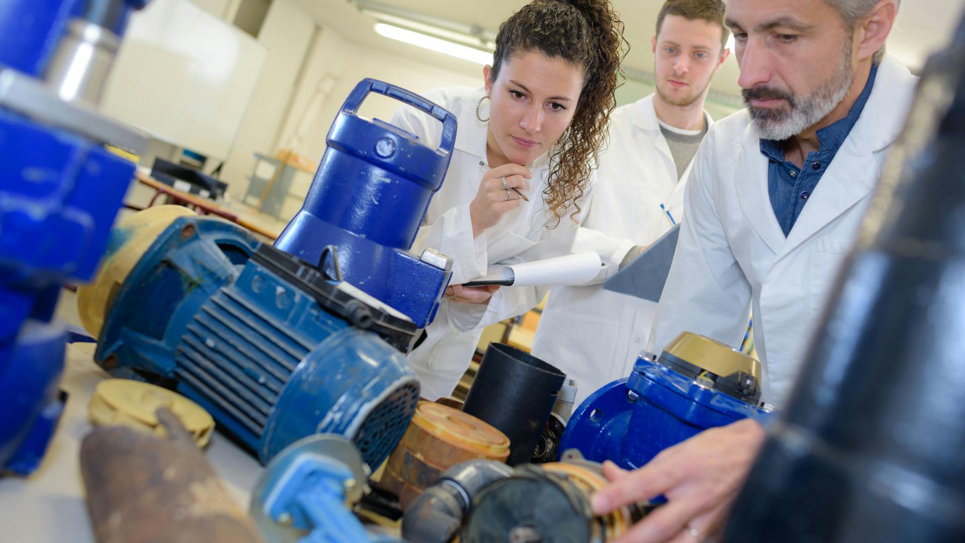 Engineers working with pumps and motors