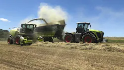 A combine and tractor working in a farm field A combine and tractor working in a farm field