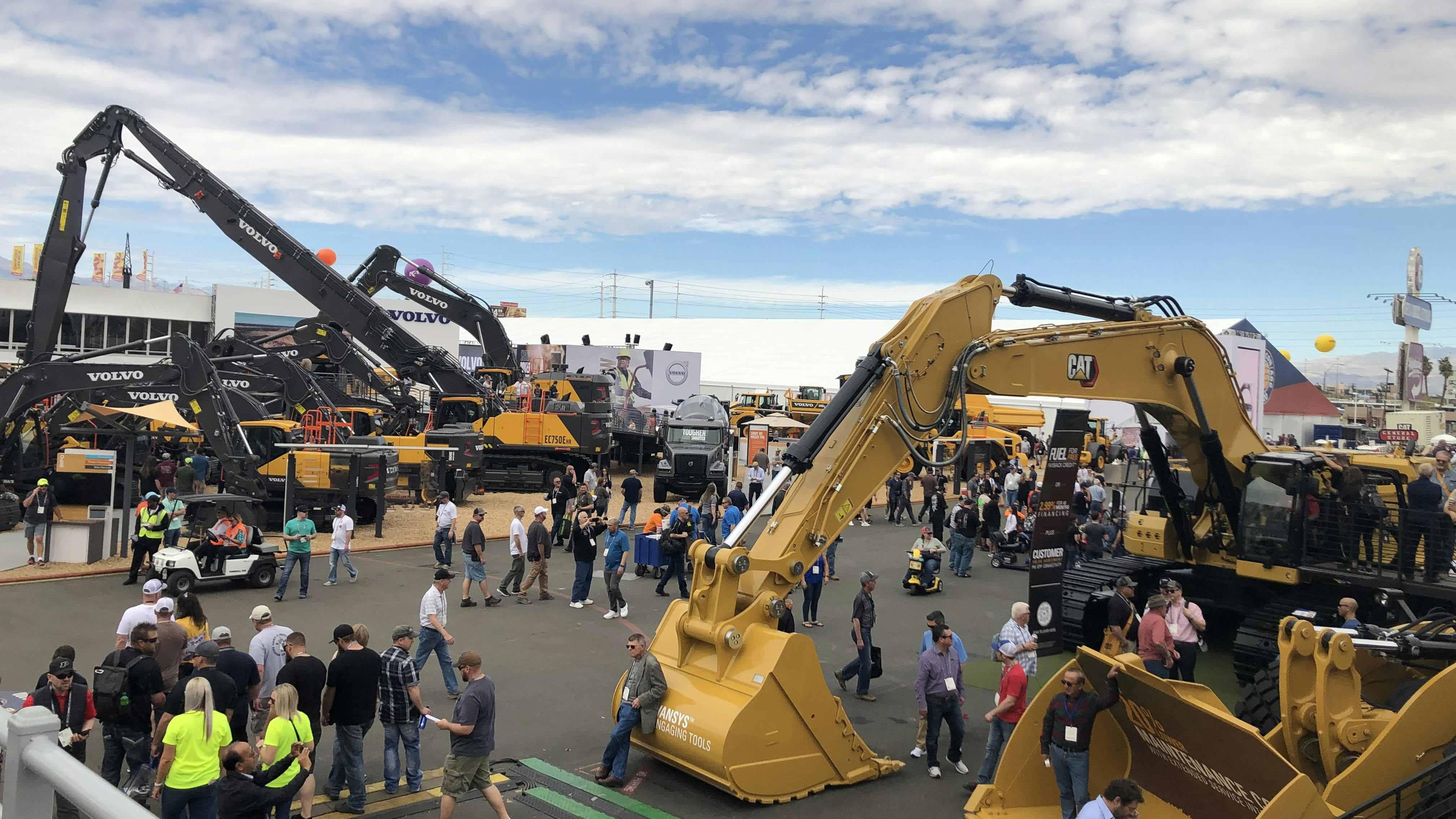 An overview of a CONEXPO outdoor lot featuring various types of construction machinery