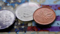 An American flag in the background with Canadian money in the foreground to depict the current tariff situation between the two countries An American flag in the background with Canadian money in the foreground to depict the current tariff situation between the two countries