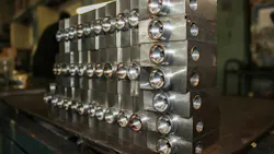 An image of stacked hydraulic valves in a manufacturing facility An image of stacked hydraulic valves in a manufacturing facility
