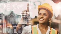 A young female engineer works on a superimposed digital screen A young female engineer works on a superimposed digital screen