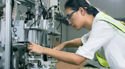 A female engineer working on a robot A female engineer working on a robot