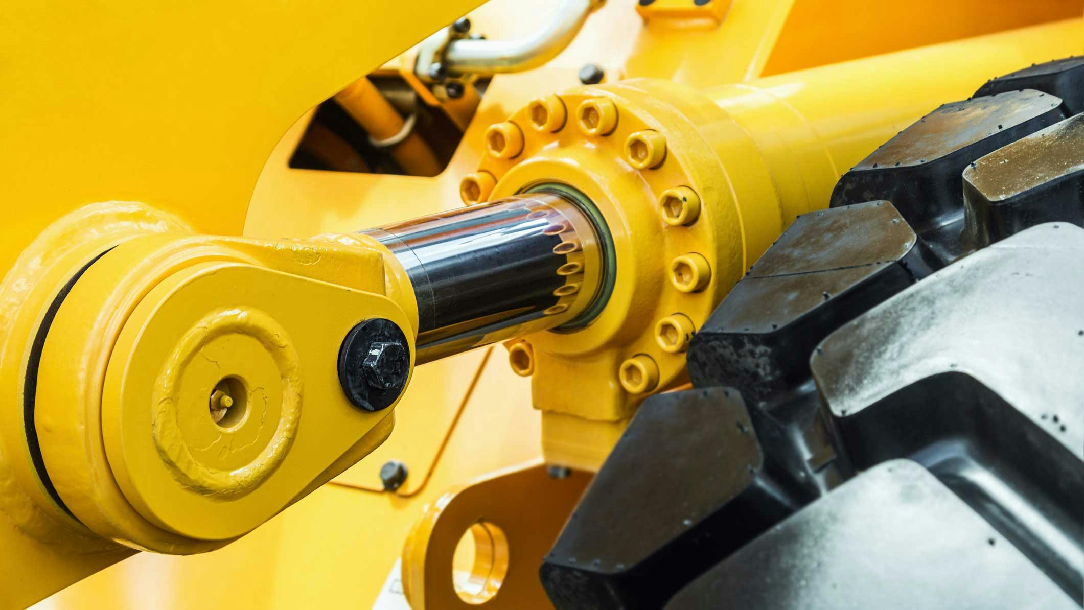 A close up view of a hydraulic cylinder on a piece of construction equipment