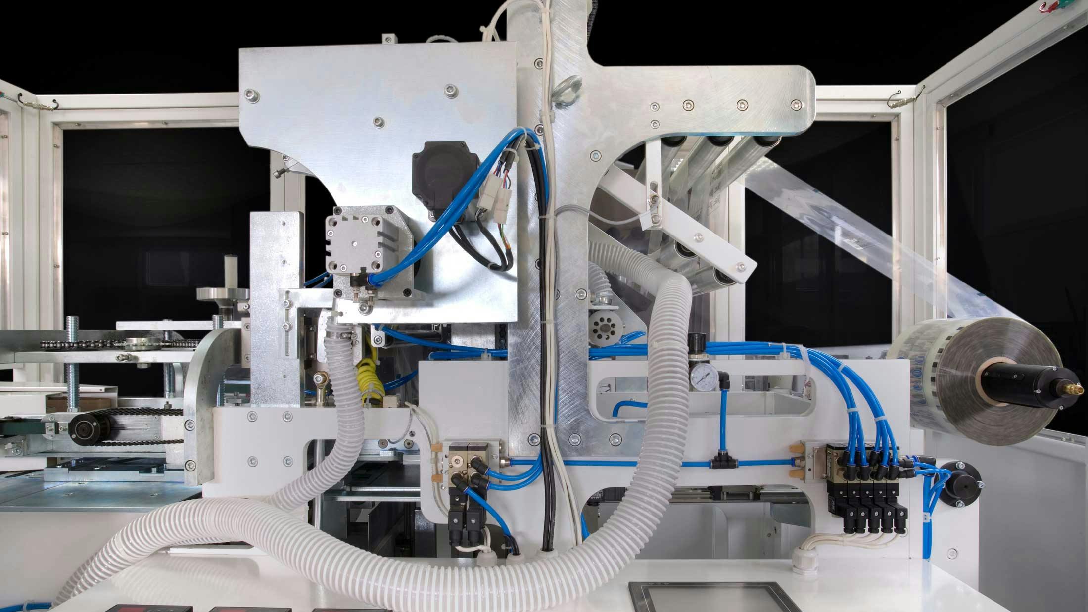 Packaging machinery with pneumatic and other components showing