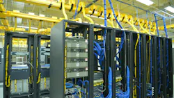 Data center racks with cables, hoses and other components visible Data center racks with cables, hoses and other components visible