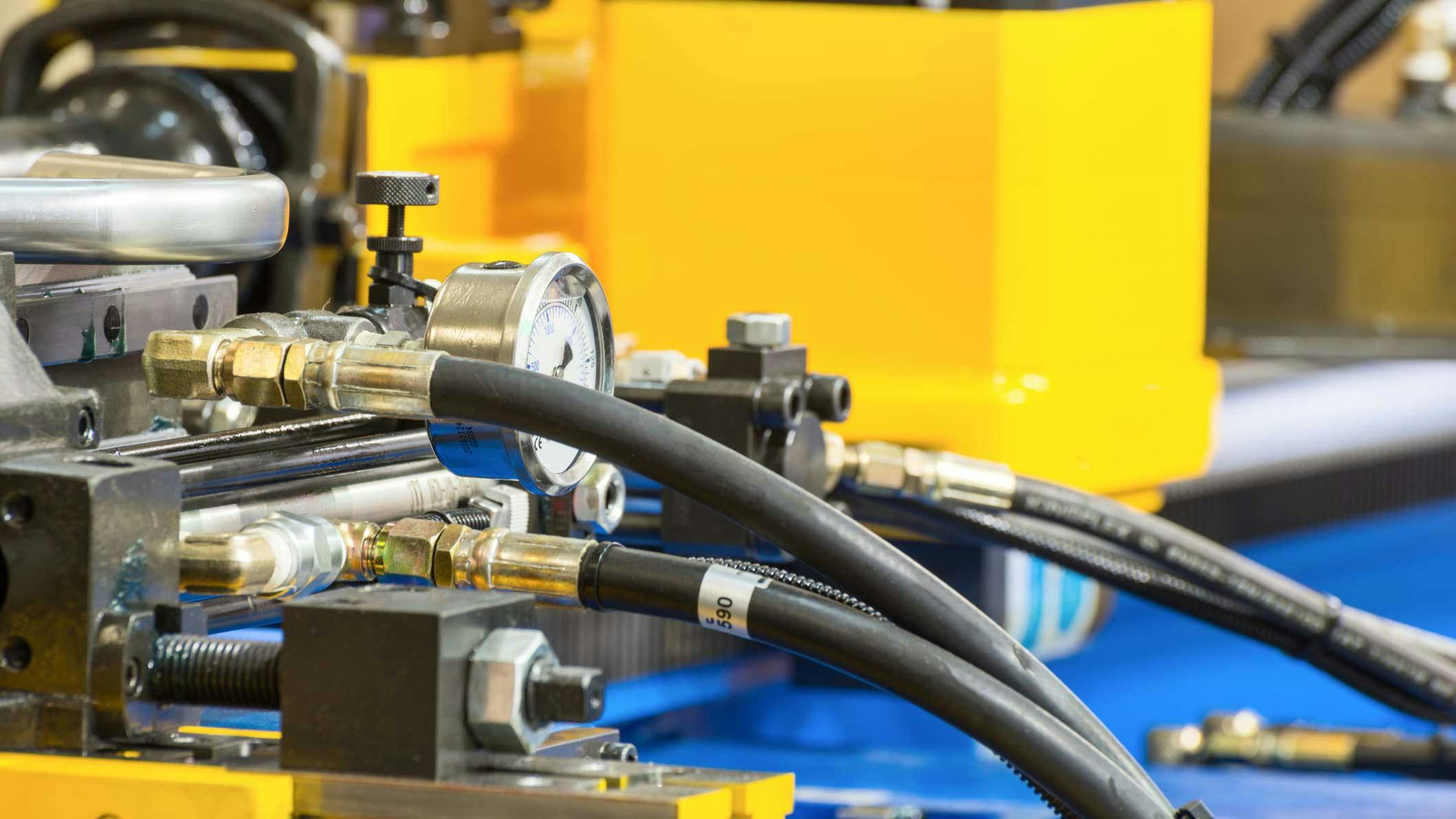Hydraulic hoses and other components on an industrial machine