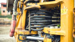 Close up view on hydraulic hoses and cylinders with oil and lubricants leaking through Close up view on hydraulic hoses and cylinders with oil and lubricants leaking through