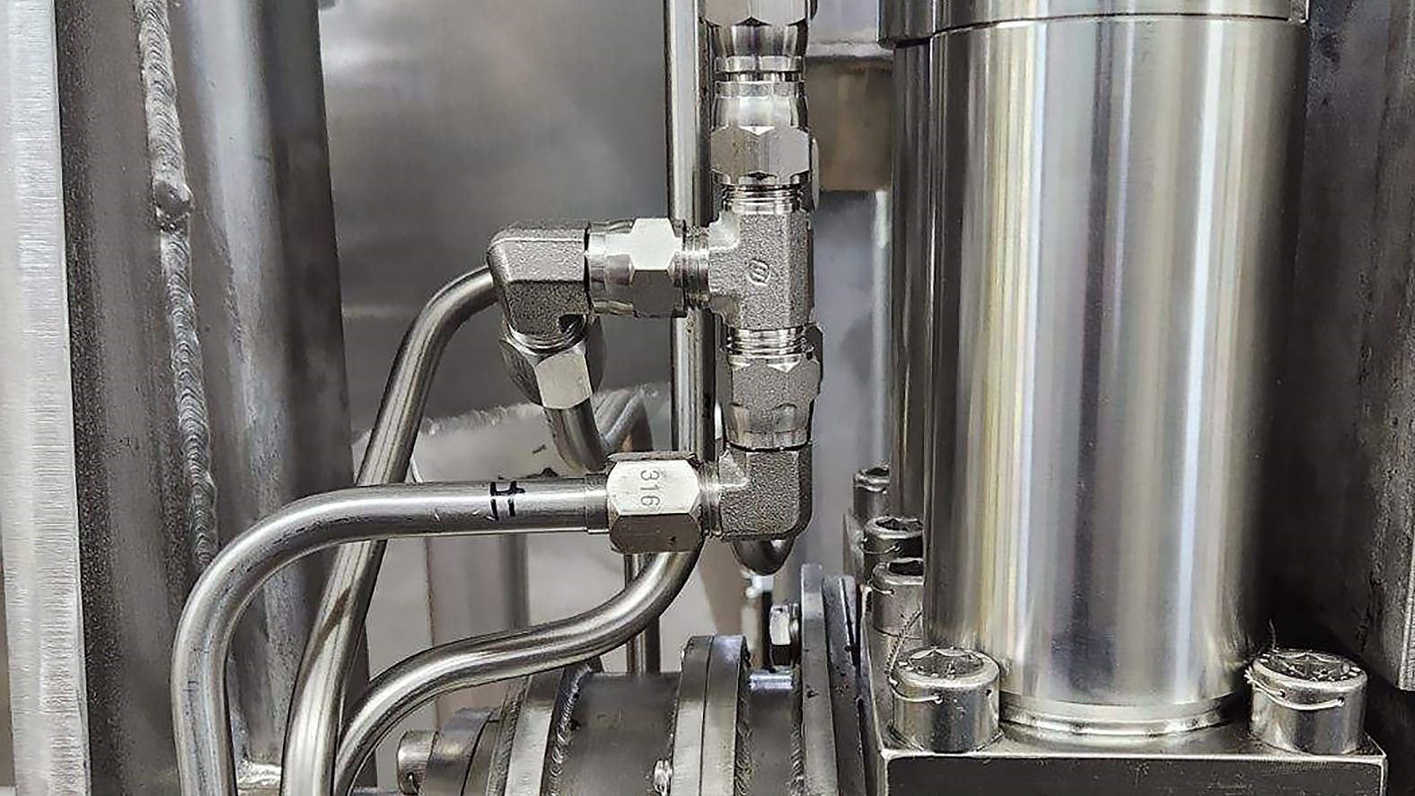 Close up of hydraulic components part of a custom system design for a hydraulic elevator