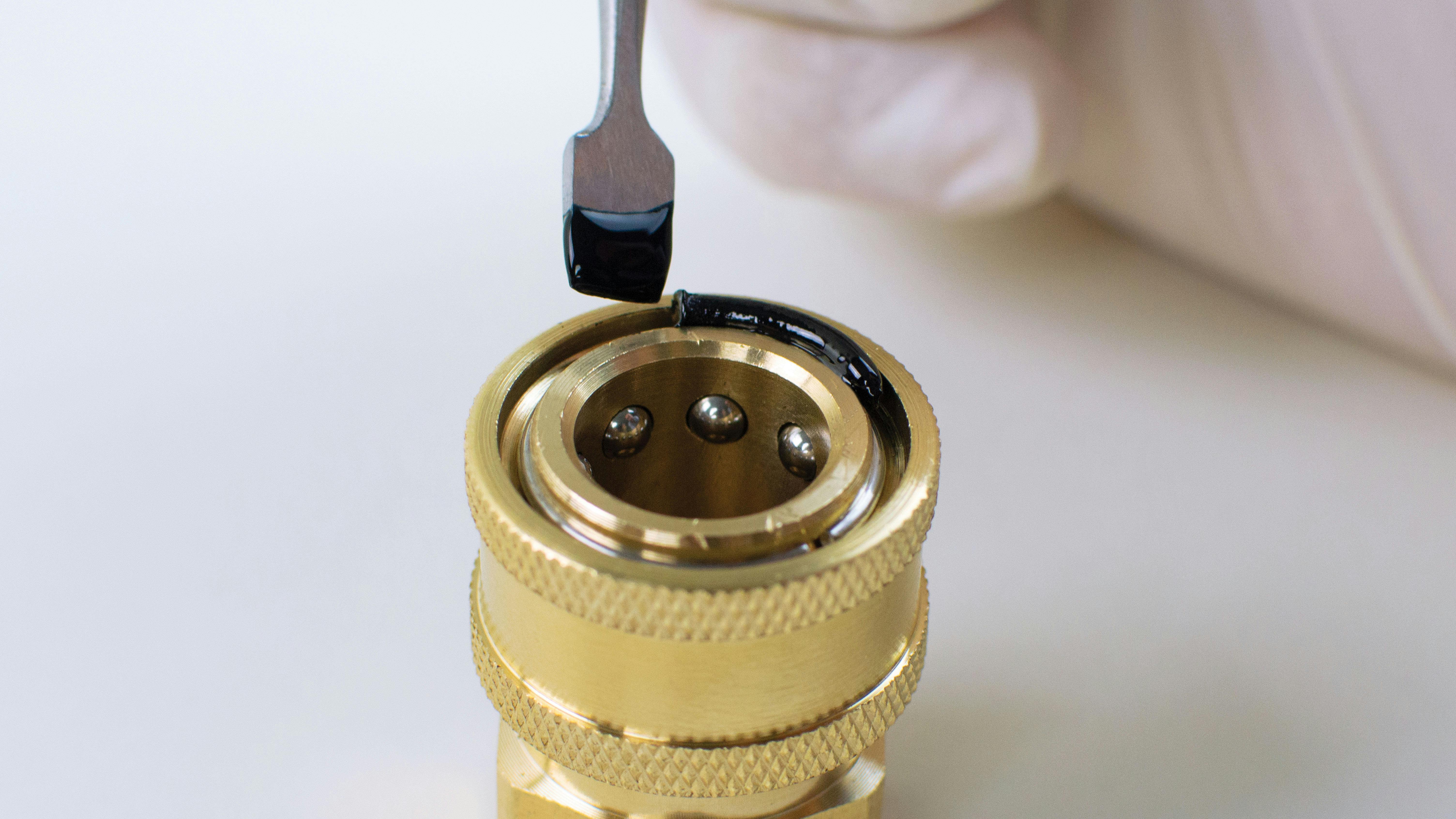 Master Bond Supreme 121AOND being applied to a component