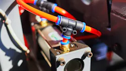 Pneumatic cylinder and tubing installed on an industrial machine Pneumatic cylinder and tubing installed on an industrial machine