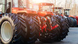 Rear view of several tractors lined up in a row Rear view of several tractors lined up in a row