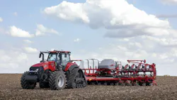 A CNH tractor pulling an implement through a farm field A CNH tractor pulling an implement through a farm field