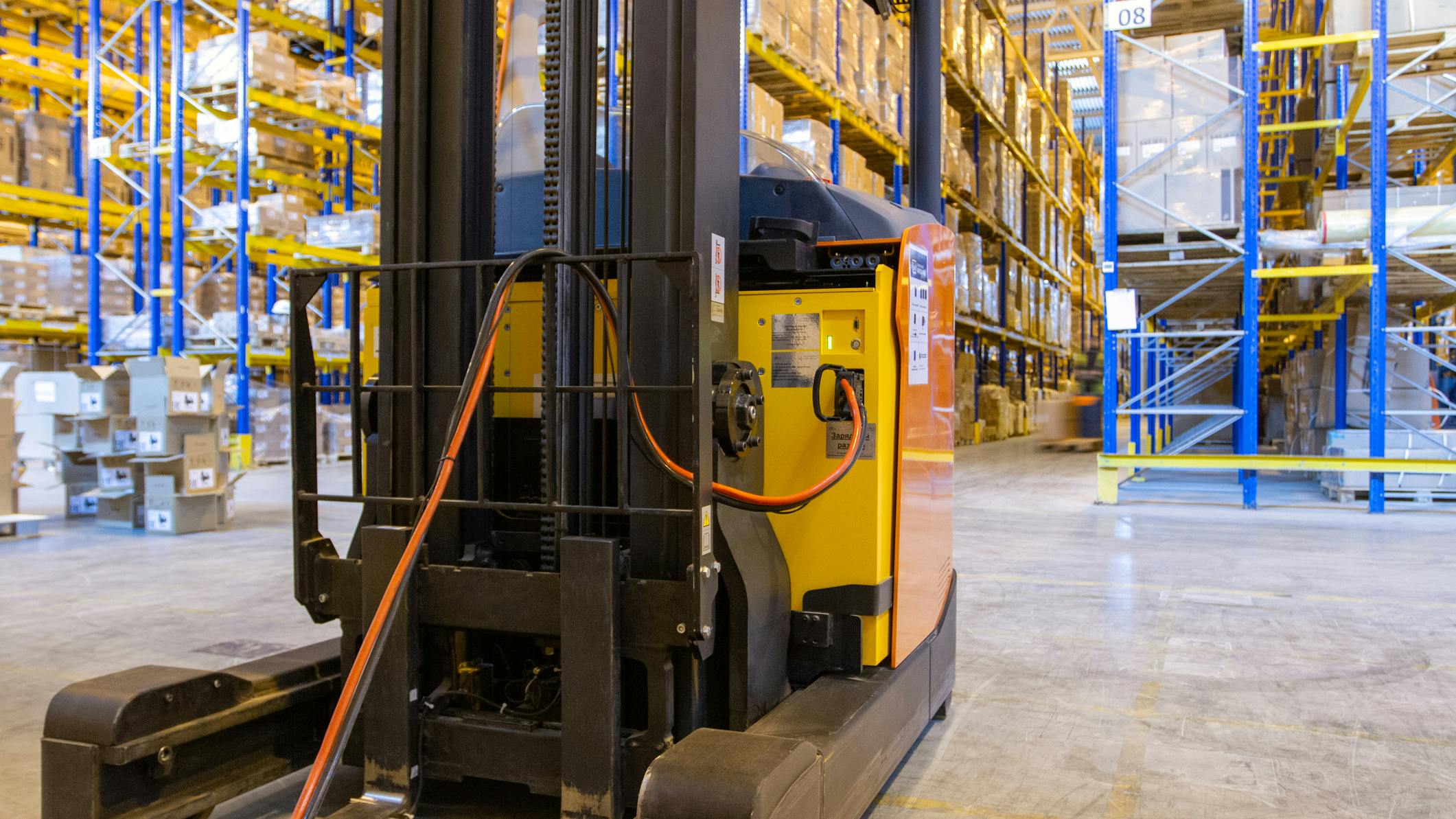 Electric forklift in a warehouse