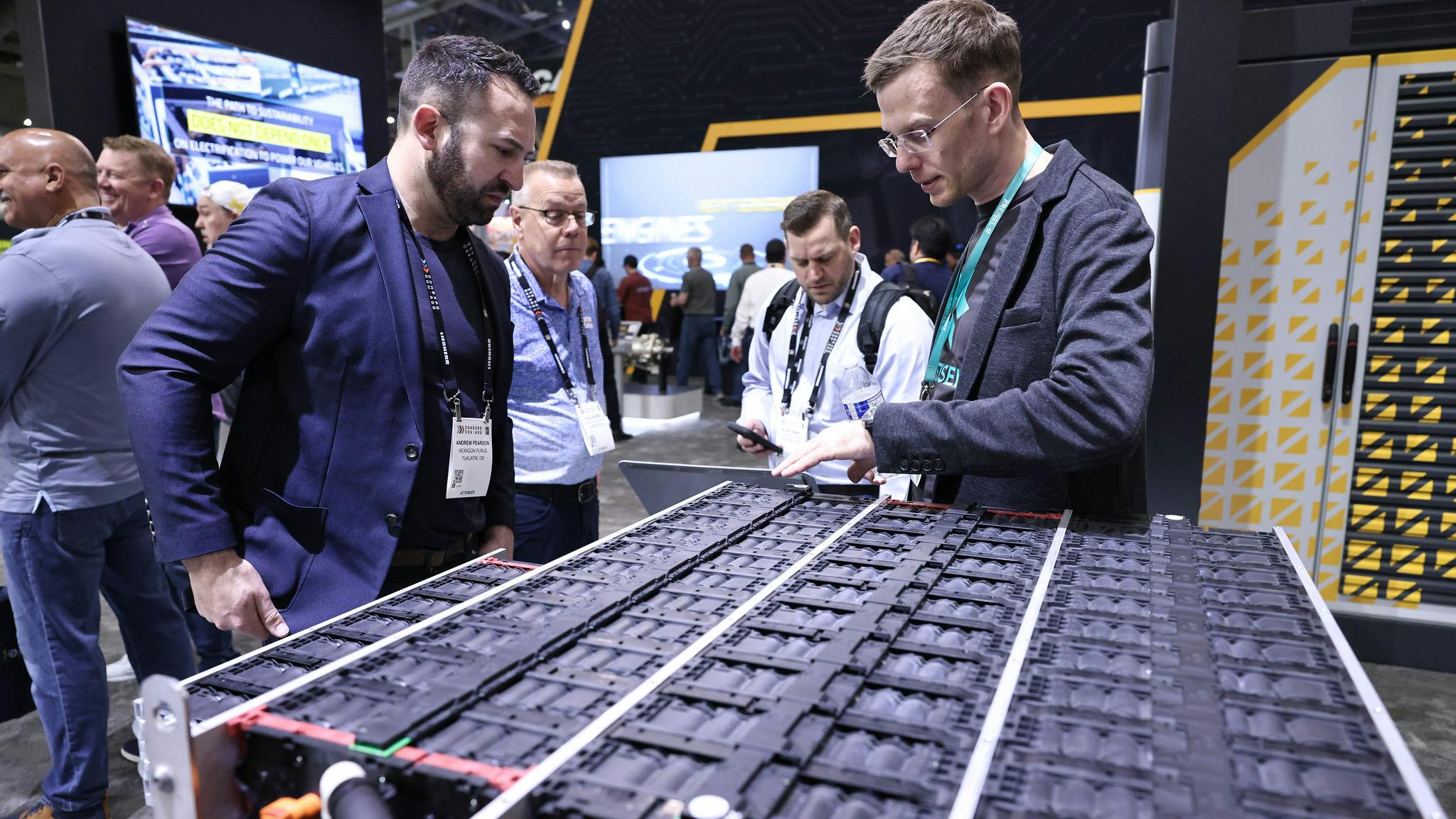 Two men talking over electrification-related technology at CONEXPO