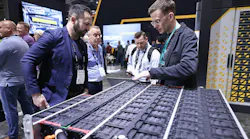 Two men talking over electrification-related technology at CONEXPO Two men talking over electrification-related technology at CONEXPO