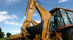 Backside view of several backhoes lined up Backside view of several backhoes lined up