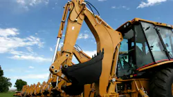 Back view of several backhoes lined up Back view of several backhoes lined up