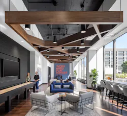 A warm, inviting game room replaced a general convenience store on the ground floor and features shuffleboard and a foosball table, plus comfortable seating where employees can take a break and recharge. A warm, inviting game room replaced a general convenience store on the ground floor and features shuffleboard and a foosball table, plus comfortable seating where employees can take a break and recharge.