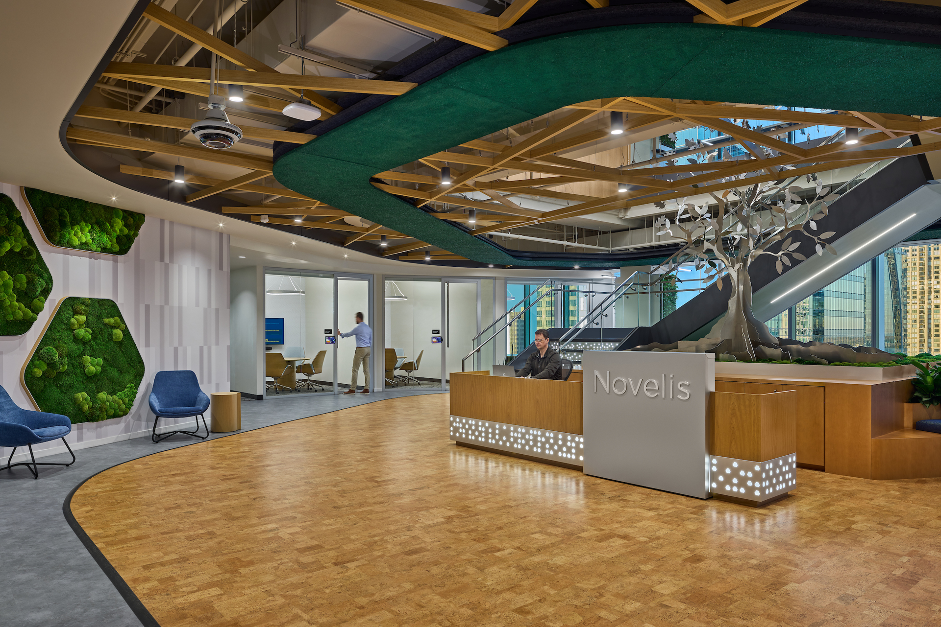 The Novelis lobby is a biophilia showcase, with cork flooring, moss walls and an aluminum tree that nods to the company&rsquo;s recycling services.