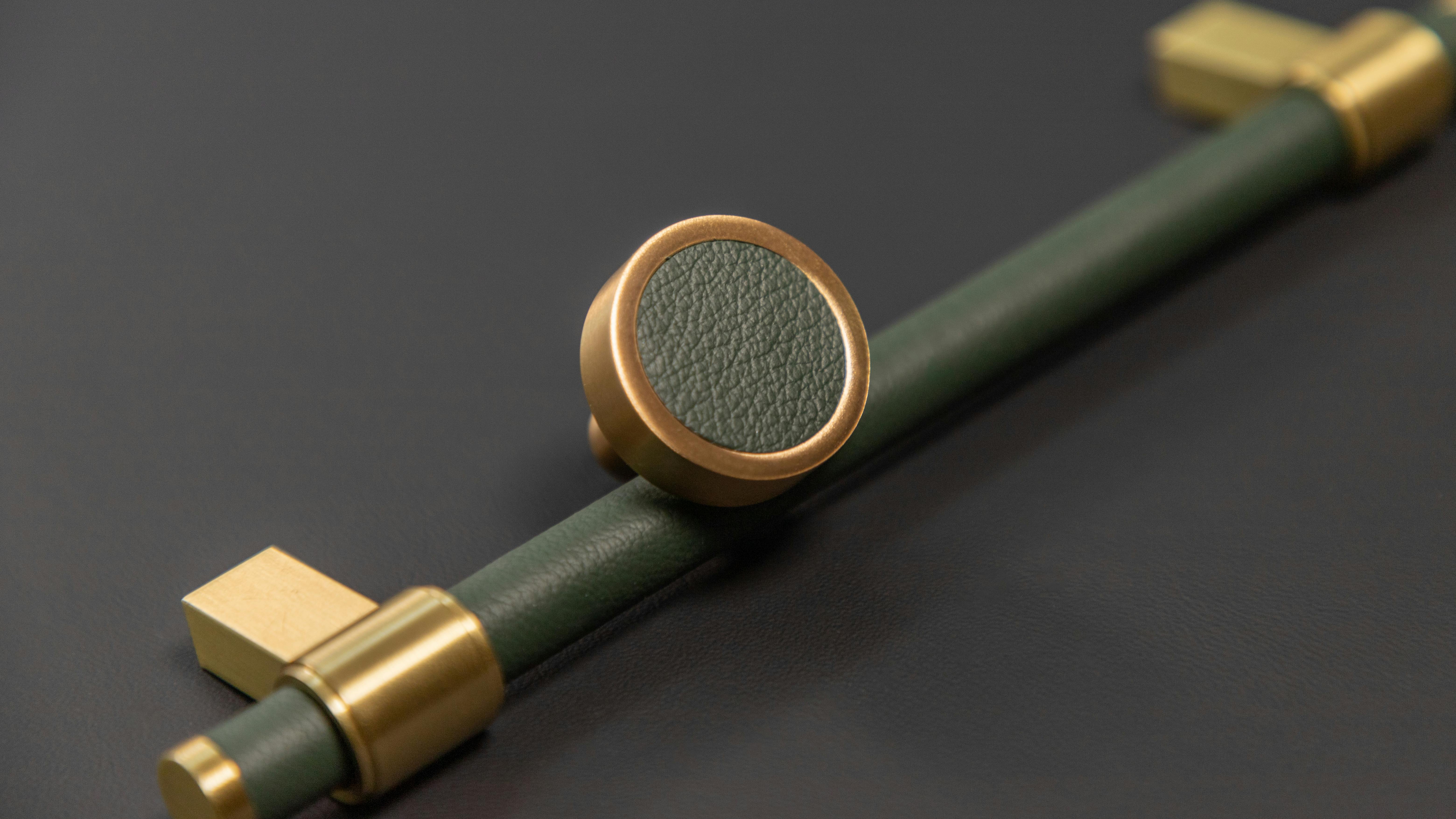 The Keeler Brass Company's Anthology Series round knob and bar pull in a royal hide evergreen.